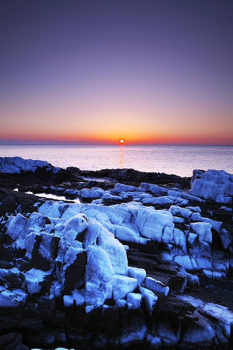 Ice spray at Cape Hanasaki and sunrise over the Pacific Ocean, Hokkaido, Japan  7 C