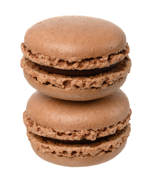 Stack of chocolate macarons on isolated background, close up Stack of chocolate macarons on isolated background, close up