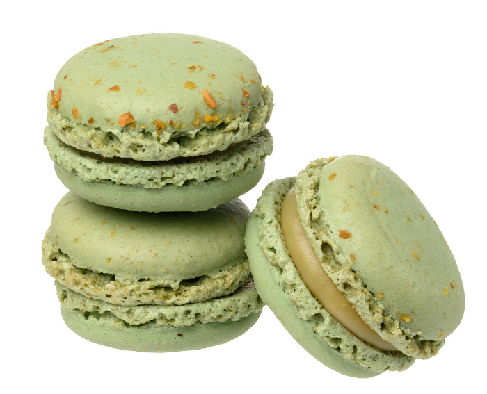 Stack of pistachio macarons on isolated background, close up Stack of pistachio macarons on isolated background, close up