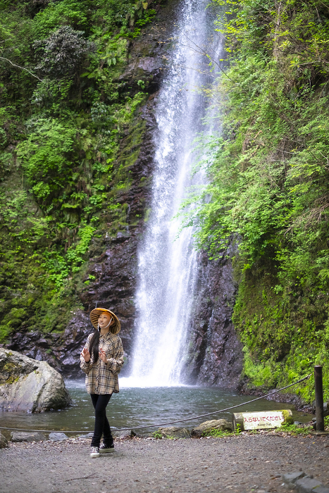 Japanese woman enjoying the waterfall and nature