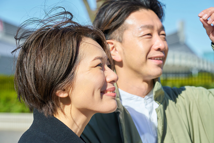 Profile of smiling Japanese man and woman.