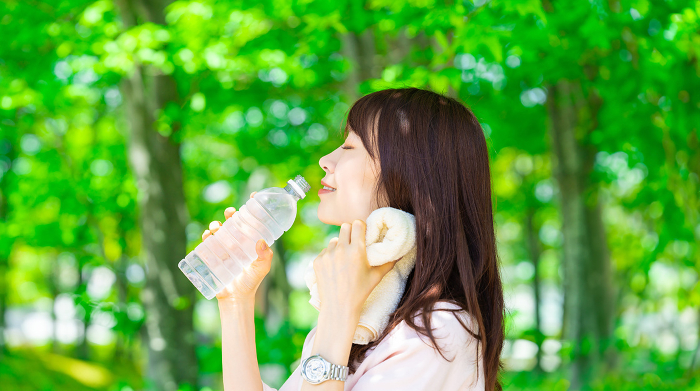 Japanese woman drinking bottled water, heat stroke prevention (People)