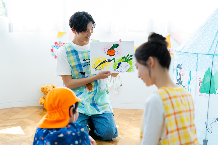Japanese nursery school teacher performing a picture-story show (Male / People)