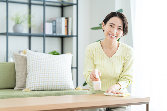 Middle Japanese woman cleaning the living room (People)