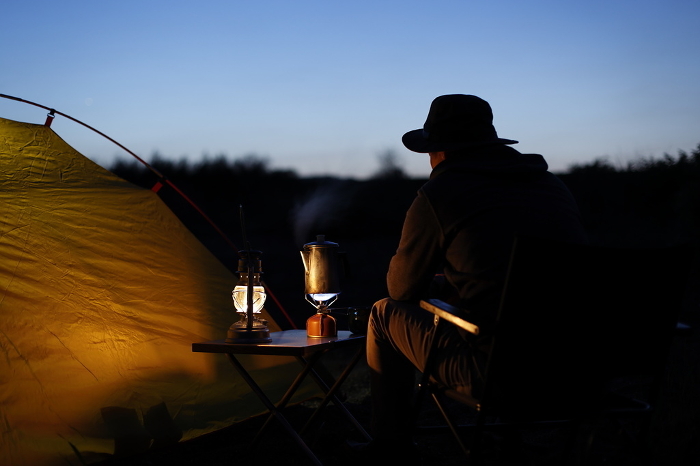 Man enjoying camping at sunset