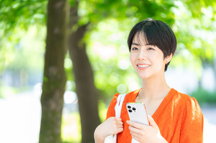 Japanese woman holding a smartphone (People)
