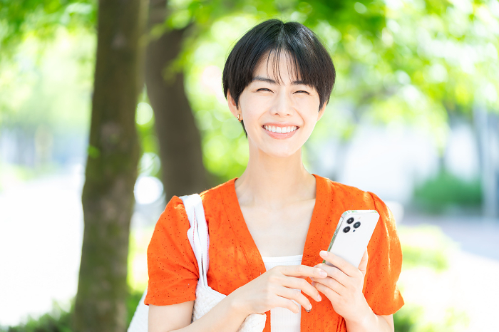 Japanese woman holding a smartphone (People)