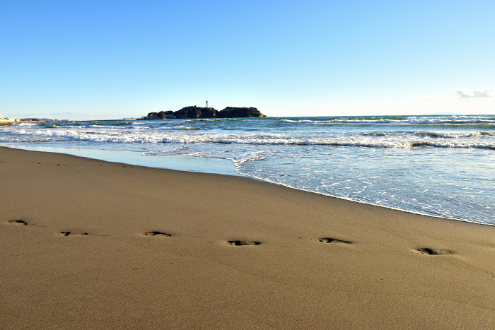 Surfer's footprints on the sandy beach of Katase Nishihama Beach