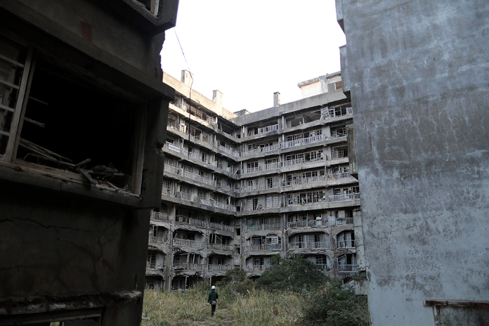 Gunkanjima  Battleship Island   December 12, 2013  Decaying mass housing complex is pictured between buildings in Hashima island, known as  Gunkanjima   Battleship island  off the coast of Nagasaki Prefecture, Japan, December 12, 2013.  The abandoned island was once populated with over 5000 of people, who were living and working in the coal mining facility.  Photo by Yuriko Nakao AFLO 