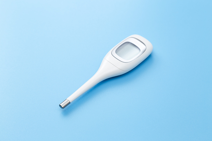 Thermometer on blue background