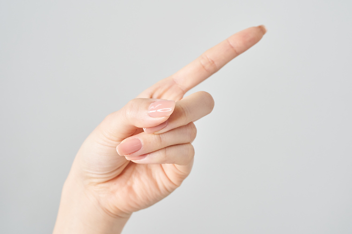 Female index finger pointing diagonally upward