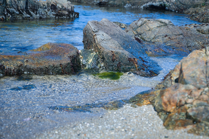 Clear blue water in a tide pool of craggy rocks