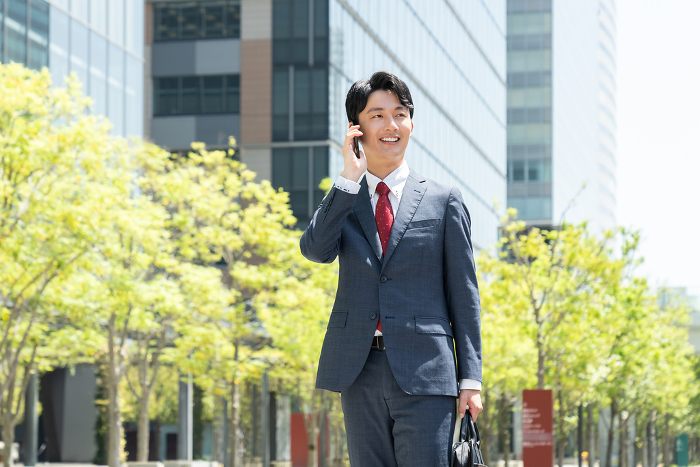 Young Japanese businessman on the phone (People)