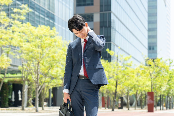 Tired young Japanese businessman (People)