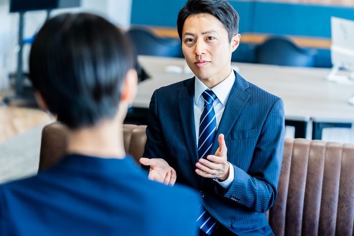 Japanese businessman having a business meeting in his office (People)