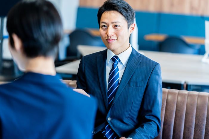 Japanese businessman having a business meeting in his office (People)
