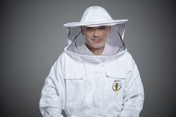 Beekeeper in protective gear ready for the hive