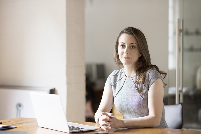 Businesswoman working at laptop in office