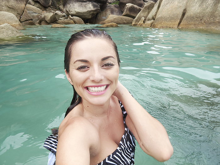 Smiling young woman swimming in Ko Samui, Thailand