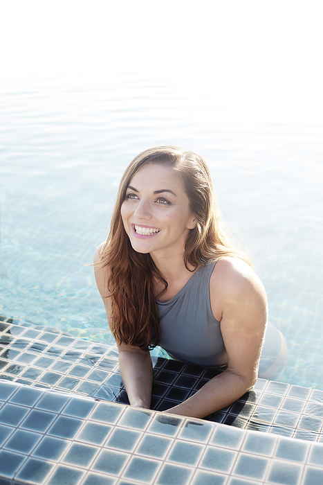 Young woman smiling in swimming pool