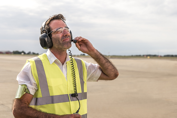 Man wearing headset on airport runway
