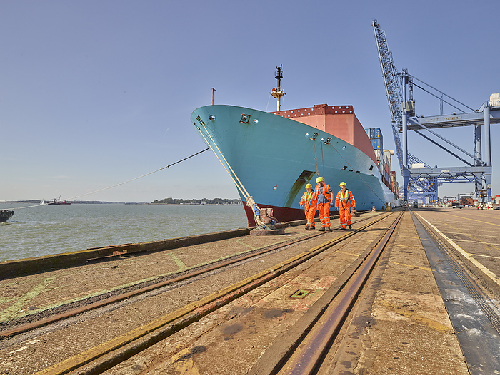 Dock workers and cargo ship at Port of Felixstowe, England