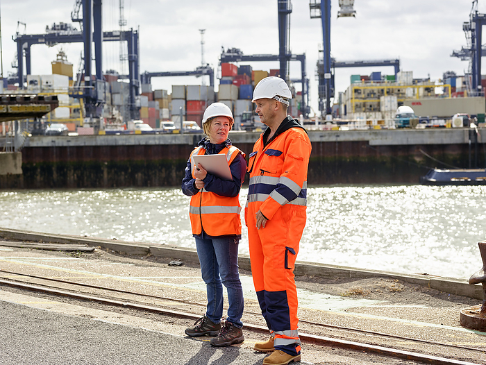 Dock workers with digital tablet at Port of Felixstowe, England