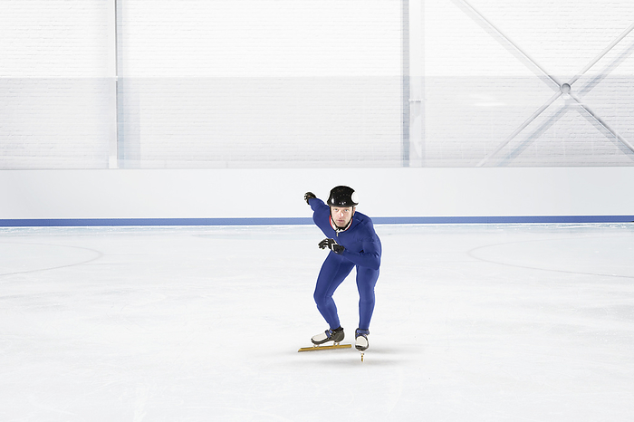 Young man practicing speed skating at ice rink