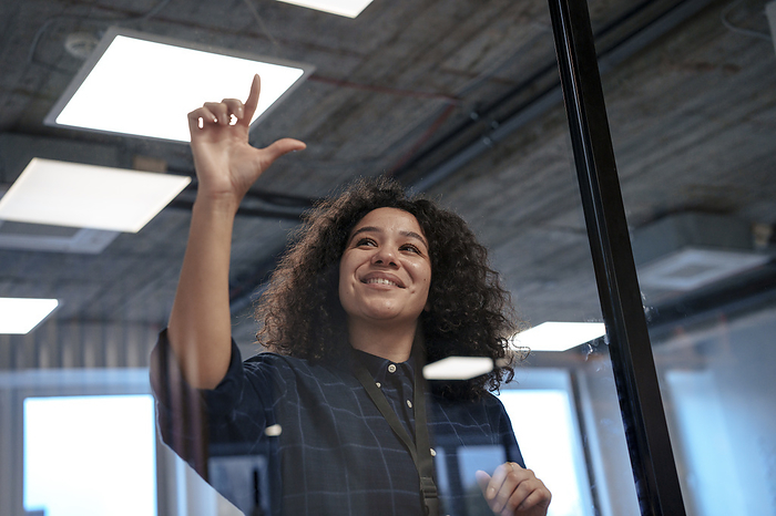 Smiling businesswoman gesturing in office