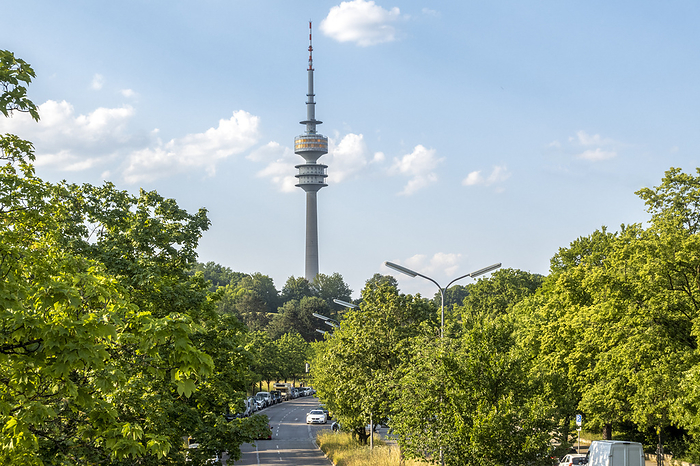 Olympic tower behind green trees in Munich, Bavaria, Germany