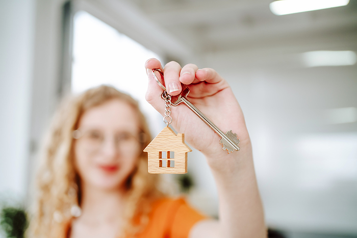 Woman holding key of new home