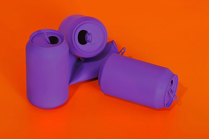 Crumpled purple cans on vibrant red background