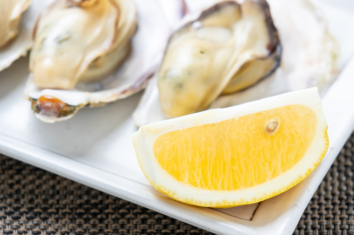 A wedge of lemon served with oysters.