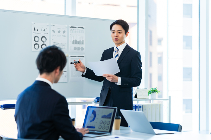 Japanese businessperson having a meeting in a conference room (Male / People)