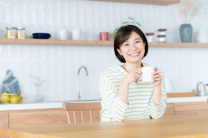 Young Japanese woman relaxing in the dining room (People)