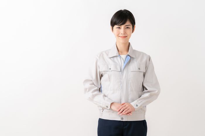 Female engineer in work clothes with white background （Japanese / People)