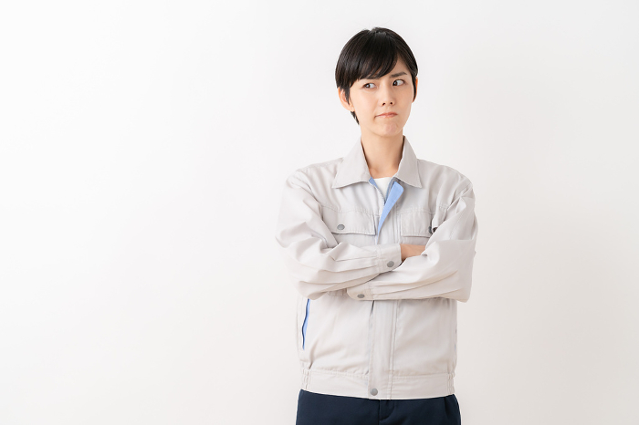 Female engineer in work clothes with white background （Japanese / People)