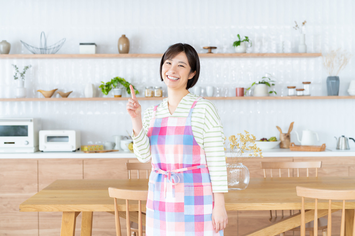 Young Japanese woman in apron.