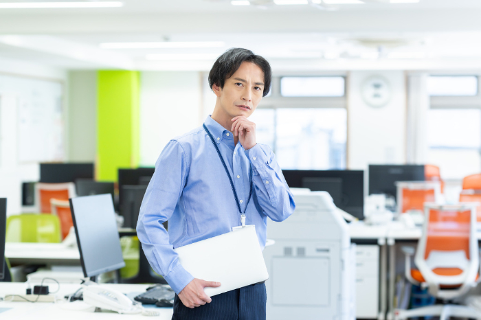 A Japanese man working in an office as a systems engineer (People)