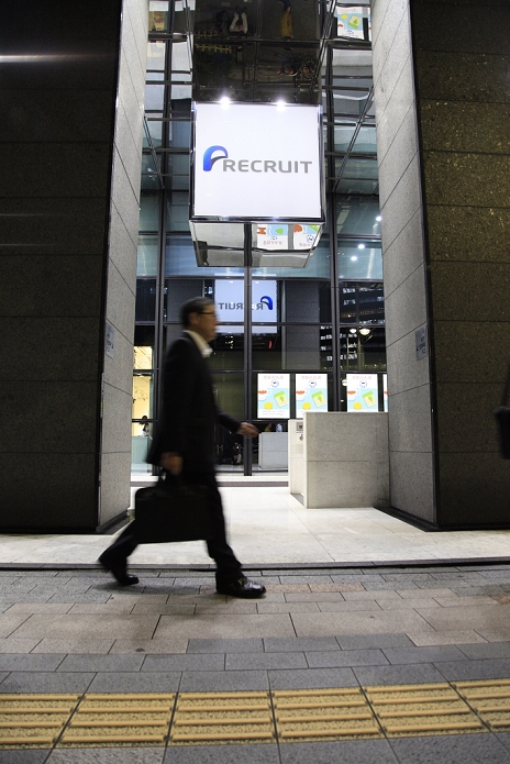 Recruit HD is newly listed on the stock exchange Market capitalization is 1.8 trillion yen October 16, 2014, Tokyo, Japan   Passers by walk near the Recruit Holdings building in Tokyo s Ginza district on Thursday, October 16, 2014. Recruit, Japan s largest staffing agency, rose 7.4 percent on its first day of trading after its  2 billion initial public offering.  Photo by Rodrigo Reyes Marin AFLO 