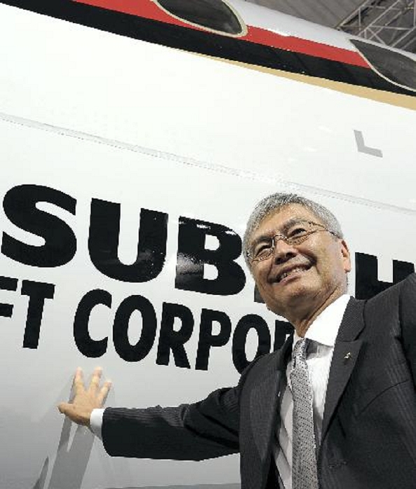 Japan s First Jet Passenger Plane First public showing of the  MRJ Hideaki Omiya, Chairman of Mitsubishi Heavy Industries, poses in front of the MRJ at 3:23 p.m. on March 18 at Mitsubishi Heavy Industries  Komaki Minami Plant in Toyoyama, Aichi Prefecture.