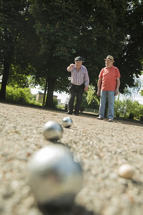 Two old friends playing boule in the park