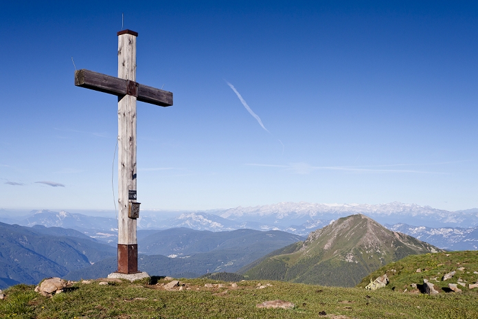Summit cross on Zanggen mountain, Schwarzhorn mountain and the Brenta group at the back, Trentino province, Italy, Europe