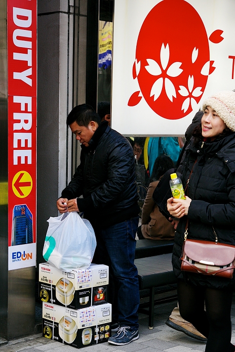 Chinese New Year  Chinese New Year Chinese tourists continue to arrive Asian tourists shopping during the Lunar New Year Holiday on February 20, 2015 in Tokyo, Japan. An asian shopper waits outside an electronics shop in Akihabara District during the Lunar New Year. Japan expects to welcome more Chinese tourists this Lunar New Year, and last moth Japan s consulate general in Shanghai issued a record 14,400 tourist visas, 260  more than December 2012.  Photo by Rodrigo Reyes Marin AFLO 