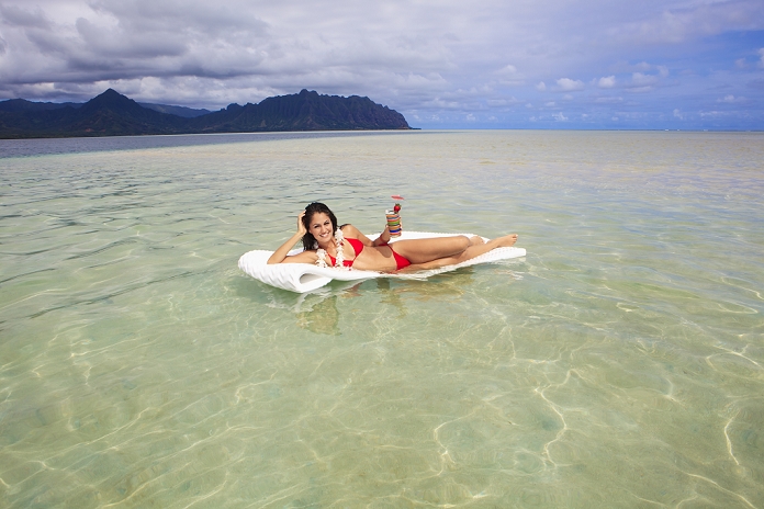 Hawaii, Oahu, Kaneohe Bay, Woman Floating On A Raft With A Tropical Drink