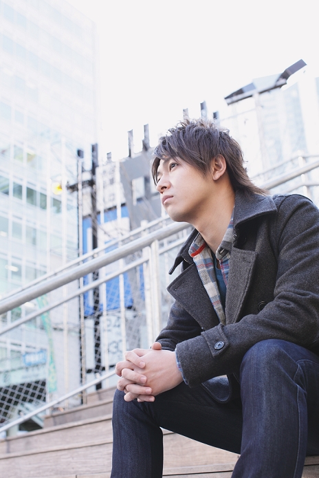 Japanese man sitting on stairs