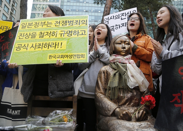 Comfort Women  Wednesday Demonstration   April 1, 2015  Peace Monument, Apr 1, 2015 : Students shout slogans around the  Peace Monument  symbolizing Korean Comfort Women during the Second World War, at a weekly anti Japan rally in front of Japanese embassy in Seoul, South Korea. The protesters lashed out Japanese Prime Minister Shinzo Abe who they insisted, attempts to whitewash Japan s wartime atrocities and refuses to acknowledge Japan s responsibility for the atrocities including sexual enslavement of women during World War II. Abe will address a joint session of Congress of the United States on April 29. A sign  L  reads, Japanese government investigate its wartime crime and make a public apology    Photo by Lee Jae Won AFLO   SOUTH KOREA 