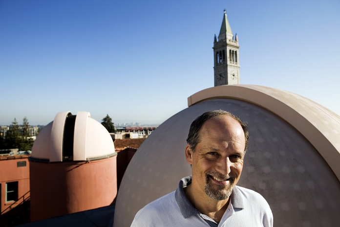 Jeffrey Marcy  2006, 5 years  Geoffrey Marcy  born 1954 , US astronomer, on the roof of Campbell Hall at the University of California, Berkeley, with the domes of 14 inch telescopes. Marcy is one of the world s leading researchers into planets around stars other than our Sun. Together with his team, using data from large telescopes at other sites, he discovered 70 of the first 100 exoplanets identified. Marcy has been Professor of Astronomy at UC Berkeley since 1999. The tower is Sather Tower  built 1914 . Photographed in May 2006.