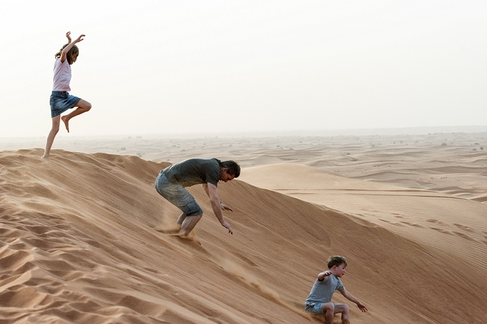 Girl jumping on desert dune