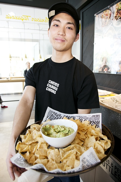 Mexican food from Australia in Harajuku  Guzman e Gomez  A member of staff offers to the guest avocado dip  guacamole  and tortilla chips during a pre opening event of the new restaurant  Guzman y Gomez  in the Harajuku shopping area of Shibuya on April 27, 2015, Tokyo, Japan. The restaurant serving burritos and Mexican fast food was founded by Steven Marks in Australia, and named Guzman y Gomez  GYG  to honor old friends with the goal of introducing Mexican food and Latin culture to the world. It will open its first Japanese branch to the public on April 29th with a special  Free Burrito Day  promotion.  Photo by Rodrigo Reyes Marin AFLO 